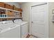 Organized laundry room with shelving, a washer and dryer, and storage space at 6402 23Rd Avenue W Dr, Bradenton, FL 34209