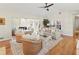 Bright living room with hardwood floors, comfortable seating, and access to outdoor spaces at 6402 23Rd Avenue W Dr, Bradenton, FL 34209