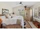 Bright main bedroom features large window with shutters, accent rug, ceiling fan, and wardrobe at 6402 23Rd Avenue W Dr, Bradenton, FL 34209