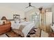 Well-lit main bedroom boasting high ceilings, shuttered windows, decorative art, and ample space at 6402 23Rd Avenue W Dr, Bradenton, FL 34209