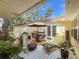 Relaxing patio space with outdoor furniture, lush greenery, and a partially covered area at 6402 23Rd Avenue W Dr, Bradenton, FL 34209