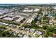 Scenic aerial view of a residential neighborhood with mature trees, nearby commercial district, and a glimpse of the water at 6442 Colonial Dr, Sarasota, FL 34231