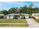 Picturesque aerial shot of a single-story home with a well-kept lawn, set in a verdant neighborhood with mature trees at 6442 Colonial Dr, Sarasota, FL 34231
