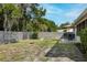 Backyard featuring fenced yard, outdoor seating, cornhole game, and shade at 6442 Colonial Dr, Sarasota, FL 34231