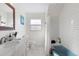Bright bathroom featuring a blue tub, subway tile, and a classic white vanity at 6442 Colonial Dr, Sarasota, FL 34231