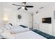 Bright bedroom featuring 2 beds, ceiling fan, and a wall-mounted flatscreen TV at 6442 Colonial Dr, Sarasota, FL 34231