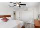 Well-lit bedroom featuring wood frame bed, white walls, and a ceiling fan at 6442 Colonial Dr, Sarasota, FL 34231