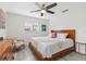 Bright bedroom featuring wood frame bed, ceiling fan, and neutral decor at 6442 Colonial Dr, Sarasota, FL 34231