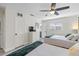 Sunlit bedroom featuring two beds, a flatscreen TV, and easy access to the bathroom at 6442 Colonial Dr, Sarasota, FL 34231