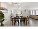 Open-concept dining area with wooden table, black chairs, and ample natural light, perfect for gatherings at 6442 Colonial Dr, Sarasota, FL 34231