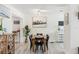 Bright dining room with a wooden table, black chairs, and beach-themed decor at 6442 Colonial Dr, Sarasota, FL 34231