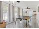 Spacious game room with a ping pong table, ample natural light, and ceiling fans at 6442 Colonial Dr, Sarasota, FL 34231
