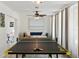 Well-lit game room featuring a ping pong table and a comfortable daybed at 6442 Colonial Dr, Sarasota, FL 34231