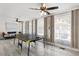 Bright game room with a ping pong table, large windows, and backyard view at 6442 Colonial Dr, Sarasota, FL 34231