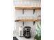Open kitchen shelving featuring glassware, mugs and modern coffeemaker at 6442 Colonial Dr, Sarasota, FL 34231