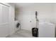 Bright laundry room with washer, dryer, and storage at 6442 Colonial Dr, Sarasota, FL 34231