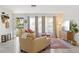 Bright living room with neutral tones, large windows, and stylish furnishings at 6442 Colonial Dr, Sarasota, FL 34231