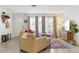 Bright living room with neutral tones, large windows, and stylish furnishings at 6442 Colonial Dr, Sarasota, FL 34231
