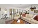 Bright living room featuring stylish furniture, a work desk, and plenty of natural light at 6442 Colonial Dr, Sarasota, FL 34231
