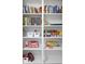 Built-in shelves storing books, games, and personal items at 6442 Colonial Dr, Sarasota, FL 34231