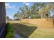 Fenced backyard with lush lawn and mature trees at 6675 Easton Dr, Sarasota, FL 34238