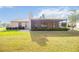 Back exterior showing a spacious yard with the screened in porch at 6675 Easton Dr, Sarasota, FL 34238