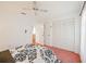 Bright bedroom with a large bed, closet and a window with sheer curtains at 6675 Easton Dr, Sarasota, FL 34238