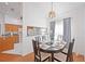 Dining area with modern lighting, wood floors, and a view into the kitchen at 6675 Easton Dr, Sarasota, FL 34238