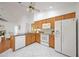 Spacious kitchen featuring white appliances, granite countertops, and tile flooring, providing ample space for cooking at 6675 Easton Dr, Sarasota, FL 34238