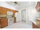 Well-lit kitchen equipped with white appliances, granite countertops, and plentiful storage, with a ceiling fan at 6675 Easton Dr, Sarasota, FL 34238
