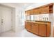 Cozy kitchenette area featuring granite countertops and ample storage, with natural light streaming through the window at 6675 Easton Dr, Sarasota, FL 34238