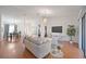 Bright living room with wood floors, neutral furniture, and modern lighting at 6675 Easton Dr, Sarasota, FL 34238