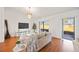 Modern living room with sliding doors to outdoor patio, neutral decor, and wood floors at 6675 Easton Dr, Sarasota, FL 34238