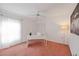 Bright office space with a ceiling fan, a closet with white doors and a modern white desk at 6675 Easton Dr, Sarasota, FL 34238
