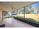 Spacious screened porch with tile flooring, ceiling fan, and views of the backyard at 6675 Easton Dr, Sarasota, FL 34238