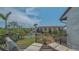 Relaxing balcony with lounge chairs overlooking lush landscaping and a sparkling community pool at 6836 Midnight Pass Rd # 6836, Sarasota, FL 34242