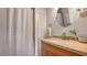 A cozy bathroom featuring a shower and a modern sink and vanity at 6836 Midnight Pass Rd # 6836, Sarasota, FL 34242