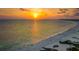 Gorgeous sunset view over a tranquil beach with gentle waves and scattered beachgoers at 6836 Midnight Pass Rd # 6836, Sarasota, FL 34242
