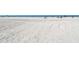 Expansive white sand beach with clear blue sky and scattered beachgoers at 6836 Midnight Pass Rd # 6836, Sarasota, FL 34242