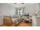 Bright bedroom with hardwood floors and a functional desk area, bathed in natural light from the window at 6836 Midnight Pass Rd # 6836, Sarasota, FL 34242