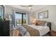 Cozy bedroom featuring a ceiling fan, a large window with a view, and stylish decor elements at 6836 Midnight Pass Rd # 6836, Sarasota, FL 34242