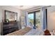 Comfortable bedroom with deck access, light blue curtains, and modern decor, creating a relaxing atmosphere at 6836 Midnight Pass Rd # 6836, Sarasota, FL 34242