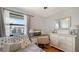 Bright bedroom featuring a functional desk, natural light, and calming decor at 6836 Midnight Pass Rd # 6836, Sarasota, FL 34242
