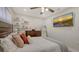 This bedroom features soft, neutral tones, a ceiling fan, and a mounted flatscreen TV for a relaxing retreat at 6836 Midnight Pass Rd # 6836, Sarasota, FL 34242