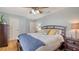 Cozy bedroom with wood-frame bed, blue accent pillows, and an adjacent nightstand with a lamp at 6836 Midnight Pass Rd # 6836, Sarasota, FL 34242