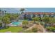Inviting community pool surrounded by well-maintained landscaping and palm trees at 6836 Midnight Pass Rd # 6836, Sarasota, FL 34242