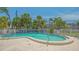 Clean community swimming pool area with lounge chairs and tropical landscaping at 6836 Midnight Pass Rd # 6836, Sarasota, FL 34242