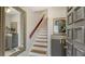 Inviting entryway features a staircase, stylish decor, and a large mirror to enhance the home's appeal at 6836 Midnight Pass Rd # 6836, Sarasota, FL 34242
