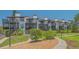 Multi-level condo buildings featuring outdoor living spaces and landscaped grounds at 6836 Midnight Pass Rd # 6836, Sarasota, FL 34242