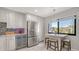 Modern kitchen with stainless appliances, stylish cabinetry, marble countertops, and a breakfast bar at 6836 Midnight Pass Rd # 6836, Sarasota, FL 34242